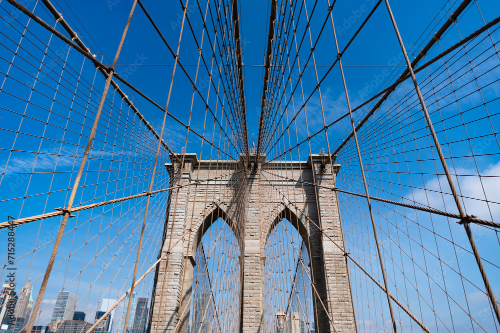 Fototapeta premium Brooklyn bridge in New York. Architecture of historic bridge in Brooklyn. Brooklyn bridge of New York city. New York bridge connecting Manhattan and Brooklyn. New York city architecture