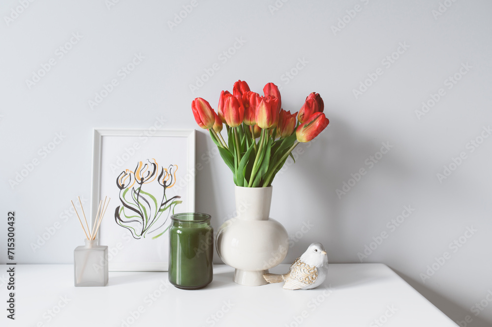 spring home decoration with flowers, bouquet of red tulips with handmade aquarelle poster on white background