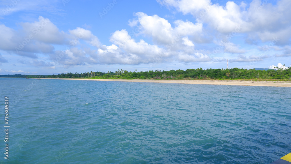 Beautiful Natural Views Of The Calm Blue Sea Of Tanjung Ular On A Sunny, Cloudy Day