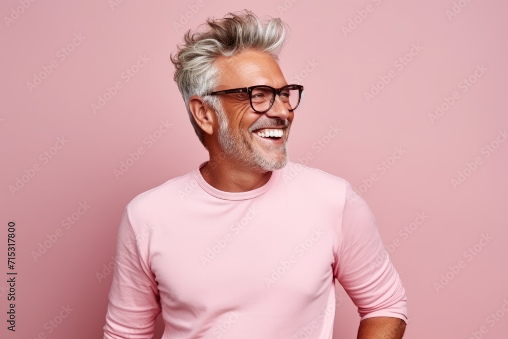 Portrait of a happy senior man in glasses against pink background. Portrait of a happy senior man in glasses against pink background.