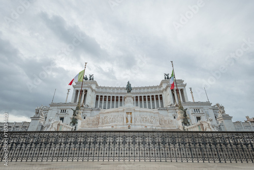 National monument of Vittorio Emmanuele II or victor emanuel the second.. Majestic white building seen from below on a cloudy day, rising high to the sky photo