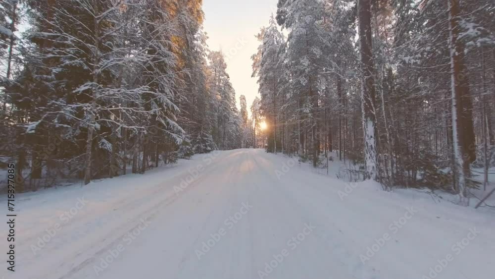 Scenic snowy drive POV in low winter sunlit forest environment Finland Scenic snowy drive POV in low winter sunlit forest environment Finland