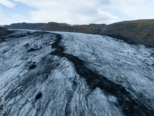 black crack over glacier from aerial view