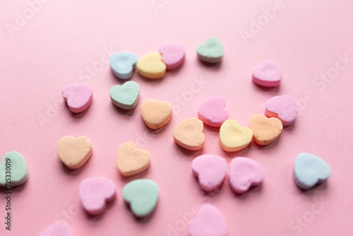 close-up of candy hearts against a pink background