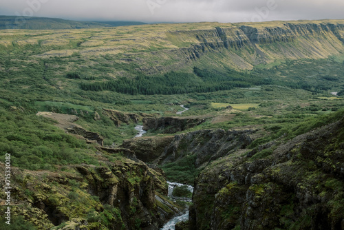 Natural Icelandic river coursing from Glymur waterfall on moody day