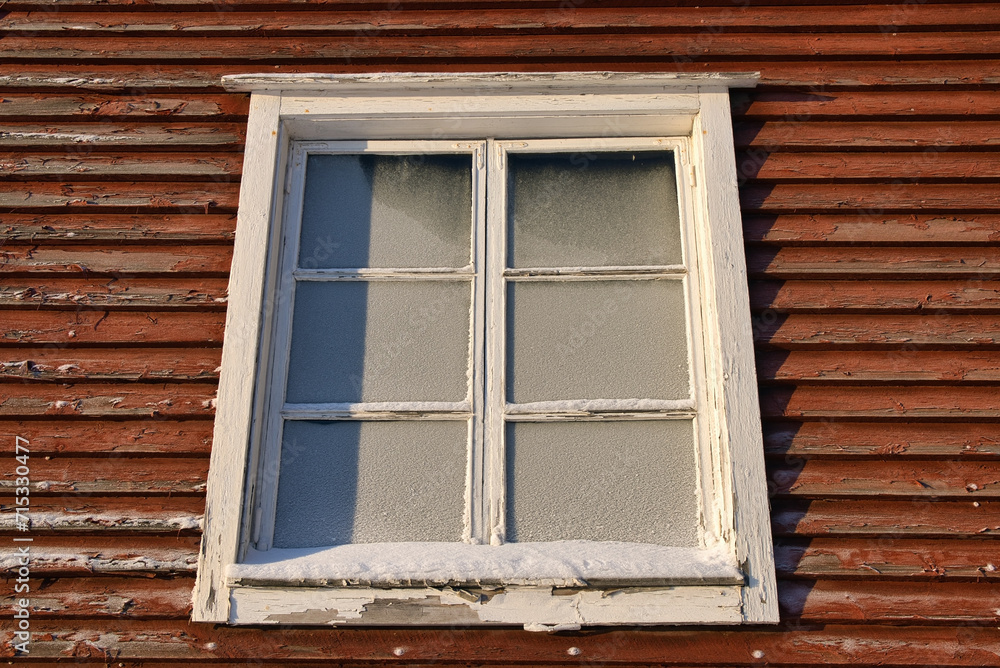 Old wooden building window with frozen glass Old wooden building window with frozen glass