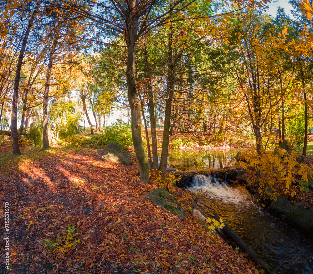 Splendid morning scene of small waterfall in Topilche Park, Ternopil city, Ukraine. Amazing autumn view of city park. Beauty of nature concept background. Splendid morning scene of small waterfall in Topilche Park, Ternopil city, Ukraine. Amazing autumn view of city park. Beauty of nature concept background.