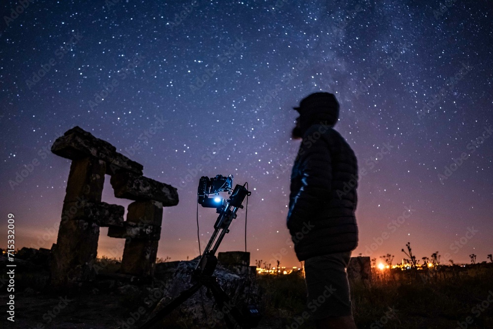 Astrophotographer with milkyway under the sky Astrophotographer with milkyway under the sky