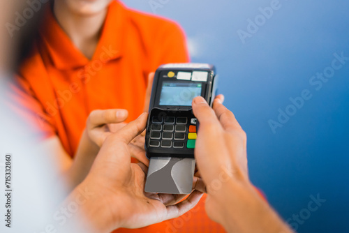 Close up of a customer pressing a pin on an EDC device to pay using an ATM card at a furniture store