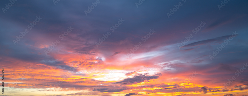 Sunrise background. Dramatic majestic scenery sunset. Sky with clouds in Sunrise sky light background. Sunrise with clouds in various shapes. Calm Sunrise sky and sun through clouds over.