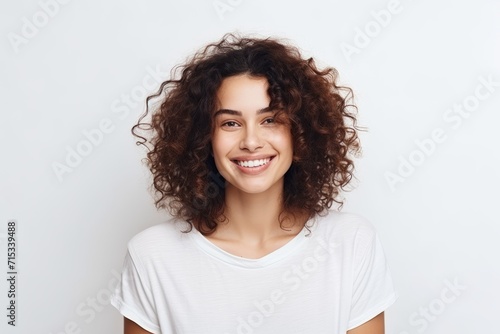 Portrait of a happy young woman with curly hair over white background