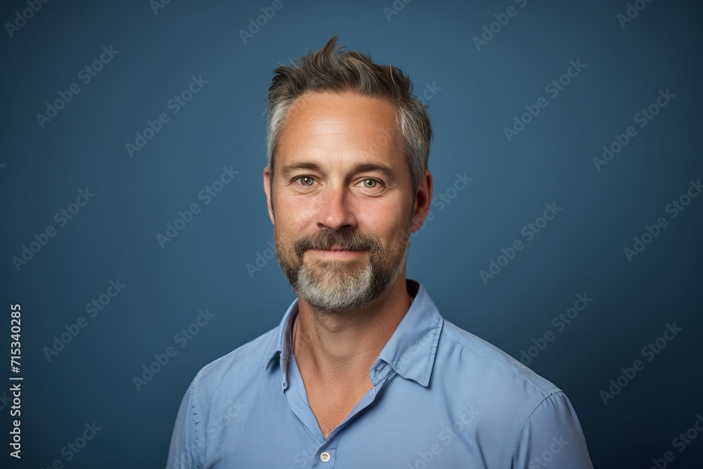 Portrait of a handsome mature man with a beard on a blue background Portrait of a handsome mature man with a beard on a blue background