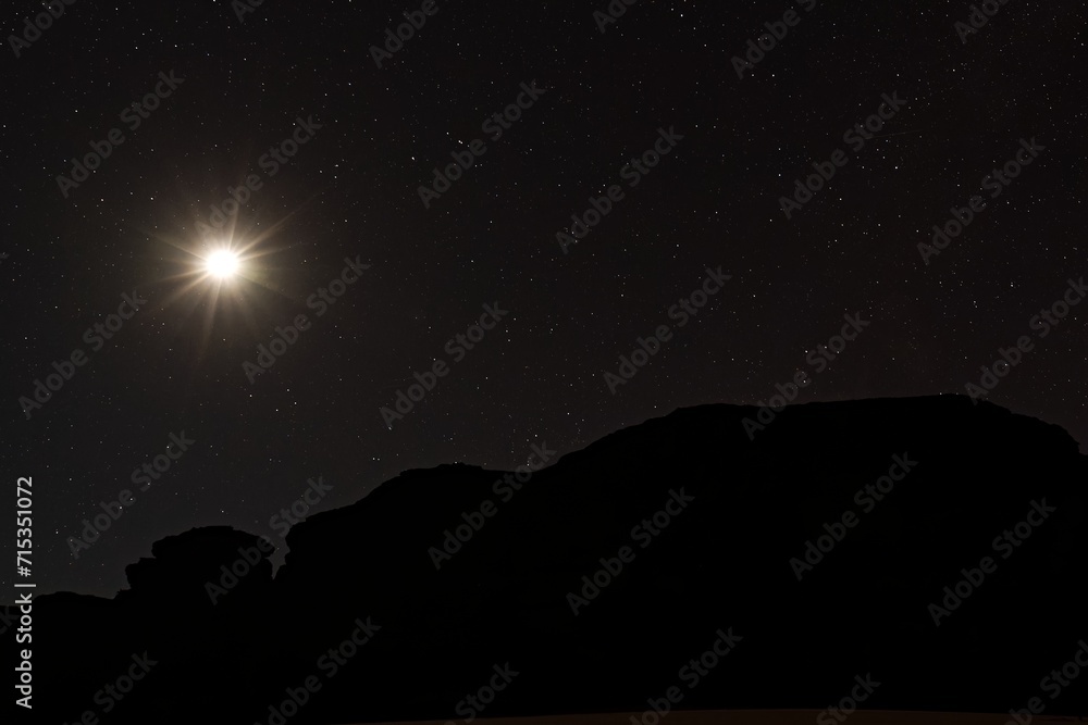 The night sky and the Tikoubaouine rock formations in the tourist area of Immourouden, near the town of Djanet. Tassili n Ajjer National Park. Sahara desert. Algeria. Africa. The night sky and the Tikoubaouine rock formations in the tourist area of Immourouden, near the town of Djanet. Tassili n Ajjer National Park. Sahara desert. Algeria. Africa.