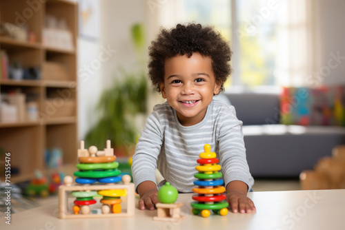 Little happy afro american dark skinned child plays with mentensorri toys, wooden educational toys at home or in kindergarten. The concept of education, child development, leisure.