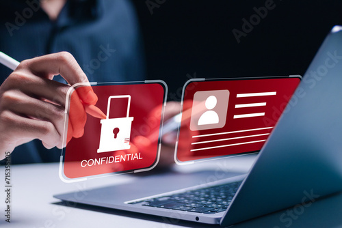 Employee confidentiality concept. Businessman use laptop to access documents data with padlock icon cyber security for managing corporate files and employee information. photo