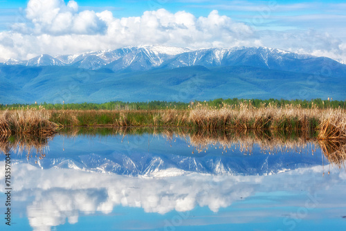 Russia. Landscape with mountains reflecting in the water on summer day. Buryatia  Tunkinskaya valley