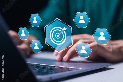 Targeting customer concept. Businessman use laptop with target customer icons for customer focus group. Digital marketing online, CRM, Data exchanges development and customer service. photo