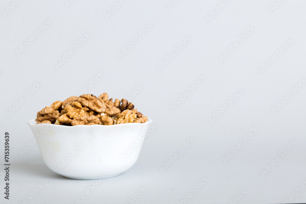 Fresh healthy walnuts in bowl on colored table background. Top view Healthy eating bertholletia concept. Super foods Fresh healthy walnuts in bowl on colored table background. Top view Healthy eating bertholletia concept. Super foods
