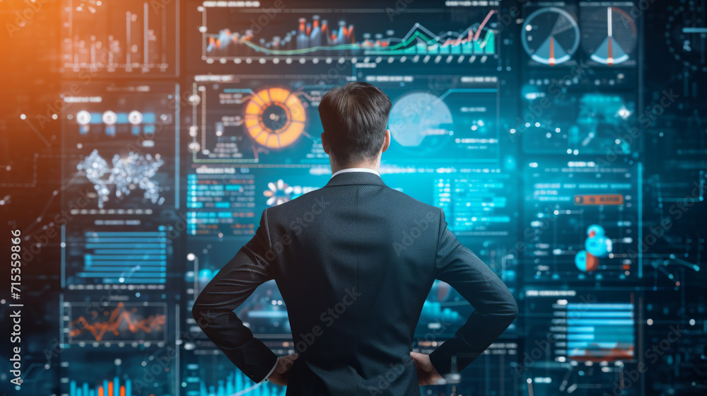 Back of a businessman in front of professional key performance indicator KPI metrics dashboard with screens and charts for sales and business results evaluation and KPI review Back of a businessman in front of professional key performance indicator KPI metrics dashboard with screens and charts for sales and business results evaluation and KPI review
