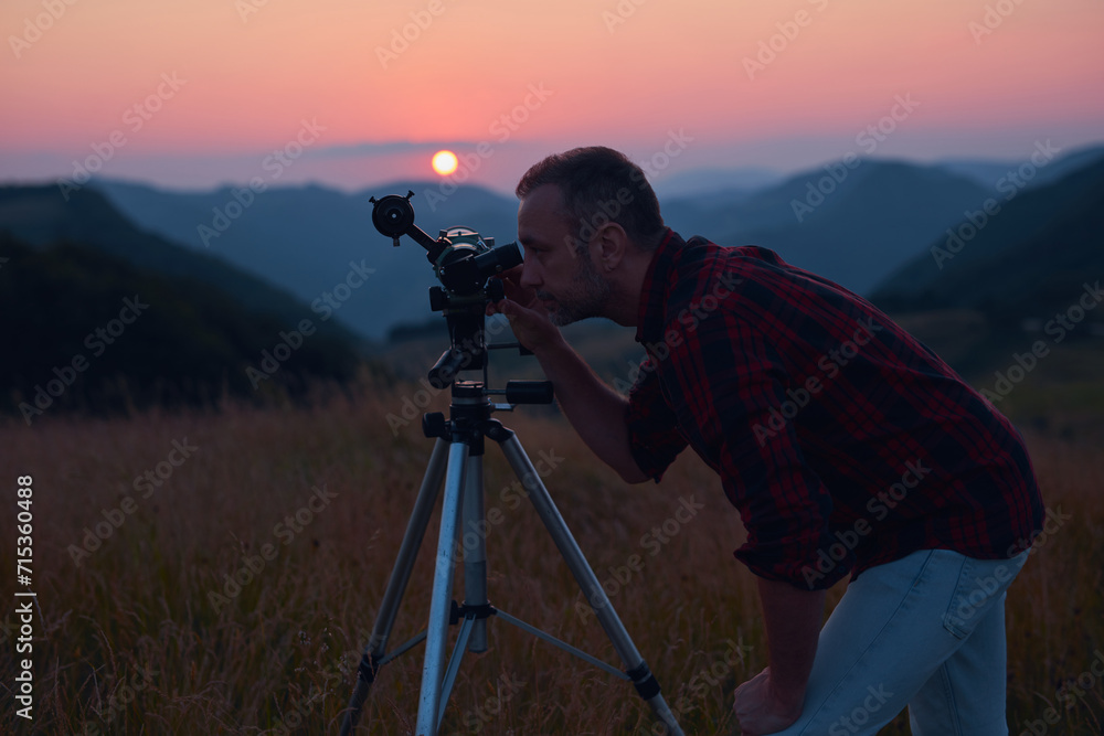 Astronomer looking at the sun with a telescope.