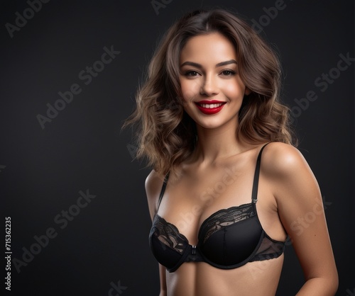 Smiling attractive young woman with sexy shapely forms  loose wavy hair in lingerie  Boudoir