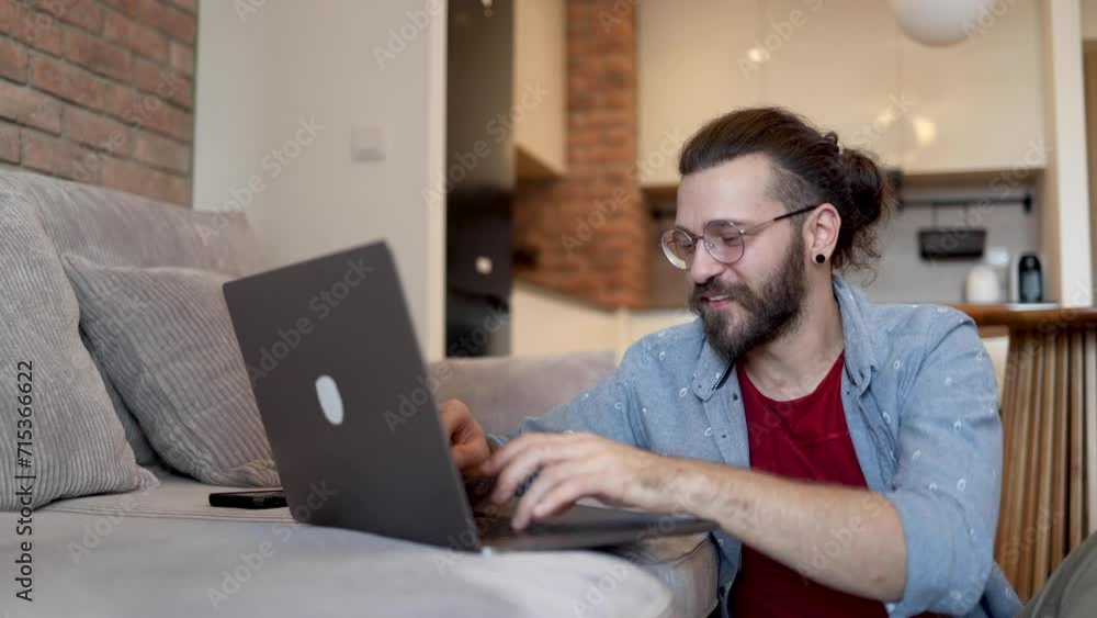 Man working on his laptop on the sofa Man working on his laptop on the sofa