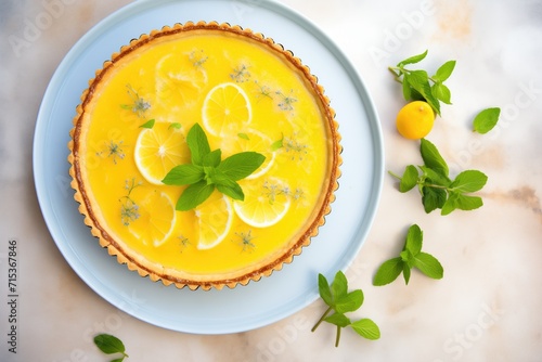 top view of a lemon tart with a mint leaf garnish