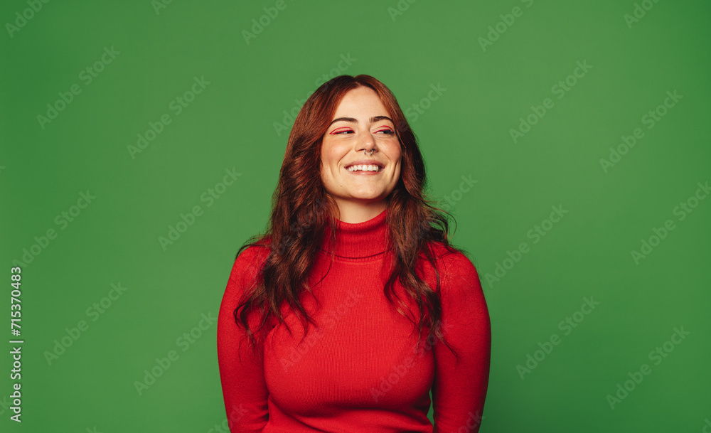 Happy woman standing on green background with trendy style. Happy woman standing on green background with trendy style.