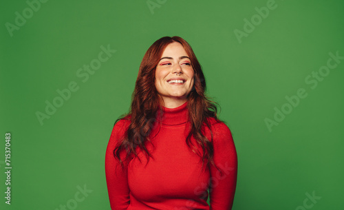 Konstfotografi Happy woman standing on green background with trendy style.