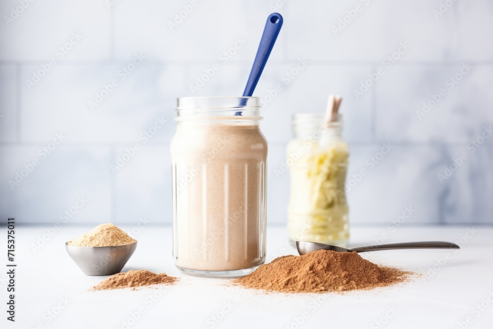 flaxseed smoothie with a scoop of protein powder beside it flaxseed smoothie with a scoop of protein powder beside it