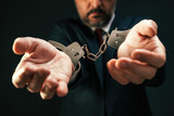 Arrested corrupted politician with handcuffs, closeup