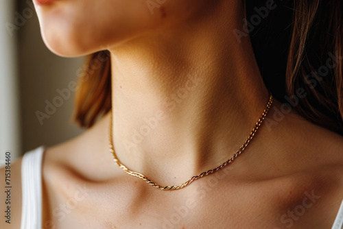 The elegance of a woman's neck adorned with a stylish gold chain necklace
