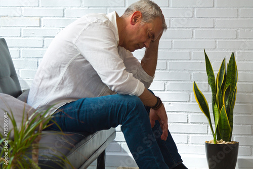 Photography sad and depressive mature man at home