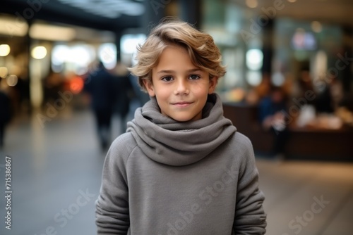 Portrait of a cute little boy in the shopping mall. Shallow depth of field.