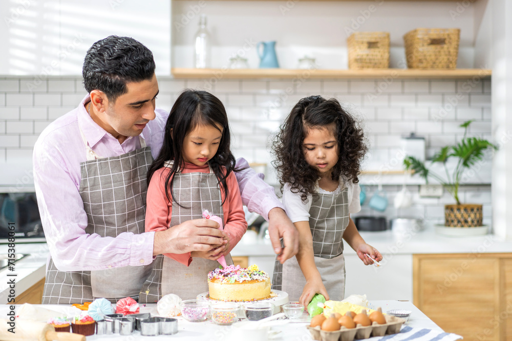 Portrait of enjoy happy love asian family father with little asian girl daughter child play and having fun cooking food together with baking cookie and cake ingredient in kitchen.