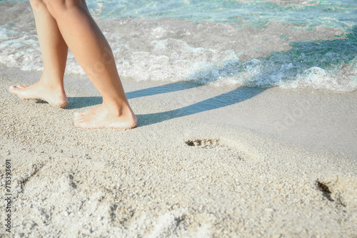 A Feet and footprints by the seashore in nature travel vacation background