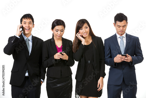 Asian business team using smartphones.