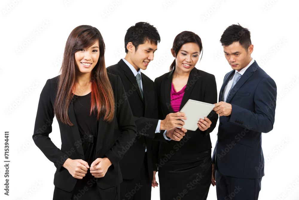 Chinese business woman with her team behind using a tablet PC. Chinese business woman with her team behind using a tablet PC.