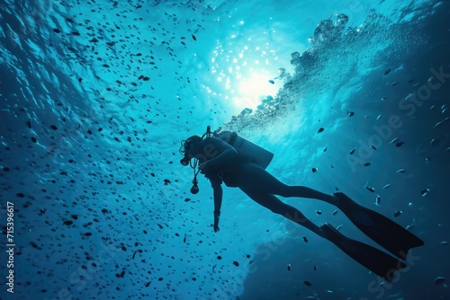 A man scuba diving in the deep blue sea underwater