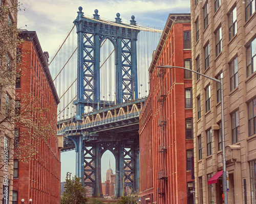  Brooklyn, NYC. Manhattan Bridge between Manhattan and Brooklyn over East River seen from a narrow alley enclosed by two brick buildings. © Igor