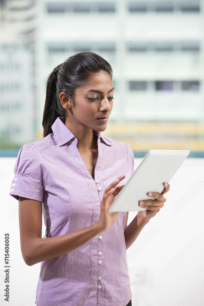 Indian office executive using a digital tablet Indian office executive using a digital tablet