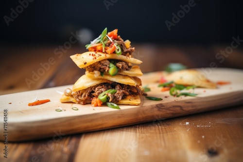 stack of beef empanadas on a wooden board