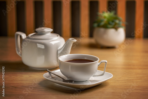 Herbal tea with white tea cup and teapot