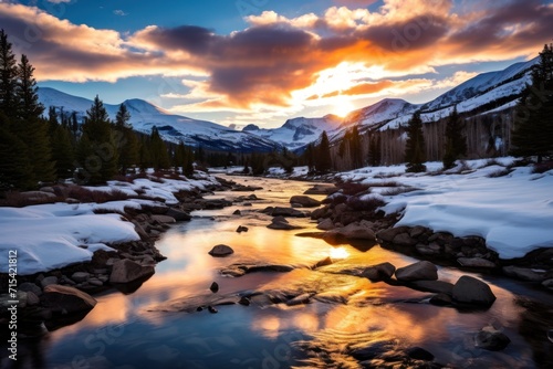  a river running through a snow covered forest next to a forest filled with tall pine trees under a cloudy sky.