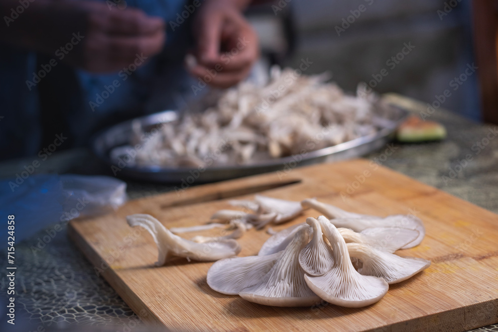 Fototapeta premium Delicious organic oyster mushrooms on wooden board at the kitchen.