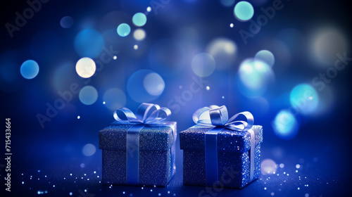 Christmas gift box or present with bow ribbon on magic blue bokeh background. Copy space for greeting text. © alexkich