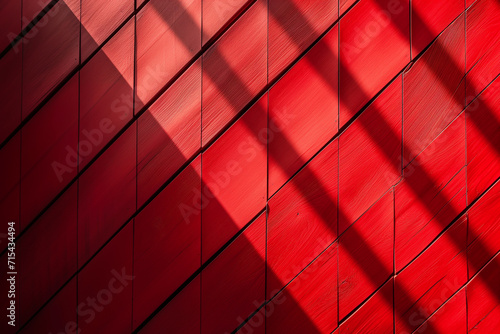Abstract pattern of red geometric panels with contrasting shadows creating a dynamic and modern background texture