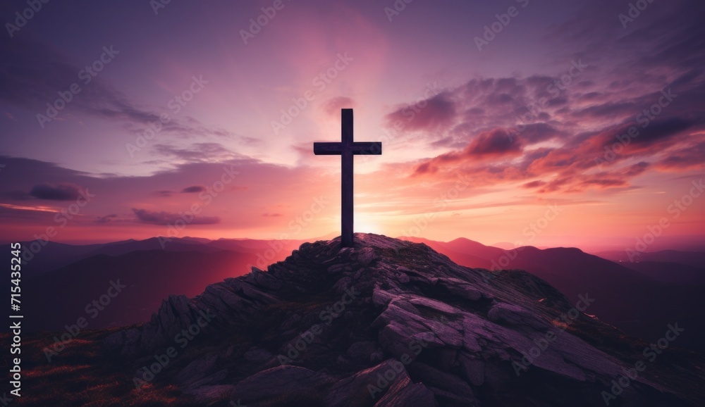 a cross is on top of a mountain at sunset.