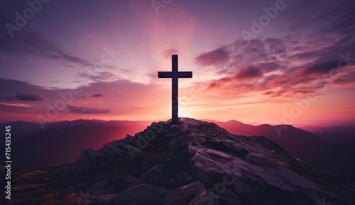 a cross is on top of a mountain at sunset.