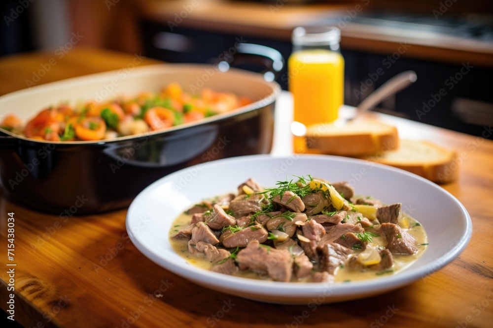 side view of beef stroganoff in a shallow dish, bread slices on the side side view of beef stroganoff in a shallow dish, bread slices on the side